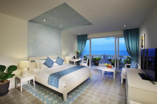 a bedroom with a bed and a view of the ocean at The Cliff Resort & Residences in Mui Ne