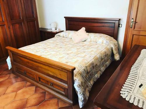 a bedroom with a wooden bed and two tables at Villa Marina Big in Laterina