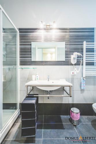a bathroom with a sink and a shower at Domus Alberti Bed & Breakfast in Rome