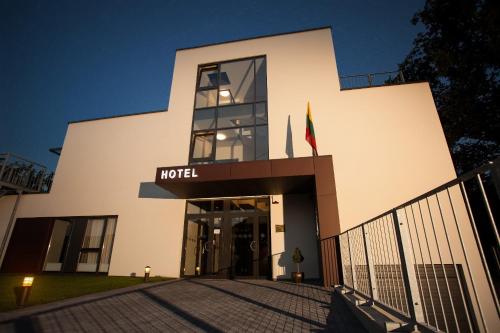 a building with a hotel sign in front of it at Hotel Babilonas in Kaunas