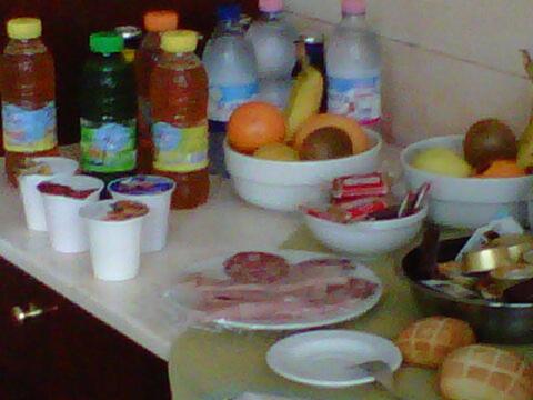 a counter topped with bowls of fruit and bottles of water at Hostiliae Ciminiera Hotel in Ostiglia