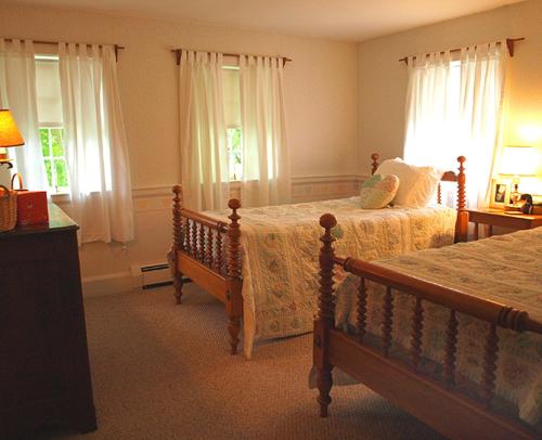a bedroom with two beds and two windows at Colonel Spencer Inn in Campton