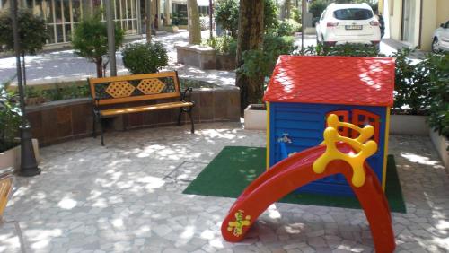 a small play set next to a bench at Hotel Silvia in Misano Adriatico