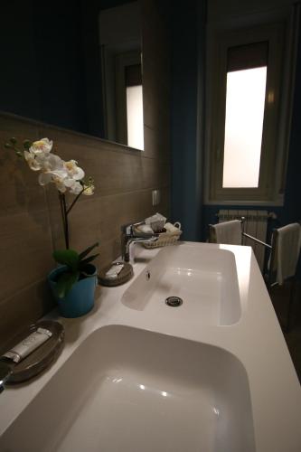 a bathroom with a white sink and a mirror at L'Alba sui Templi in Agrigento