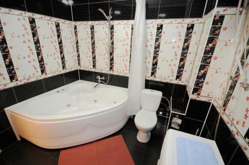 a bathroom with a bath tub and a toilet at Wonderful apartment on street Stefan cel mare 132 in Chişinău