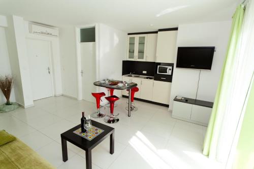 a living room with a table and a tv at Apartment Crikvenica, Vinodol 3 in Crikvenica