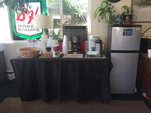 a table with a black table cloth next to a refrigerator at Marco Polo Motel in Seattle