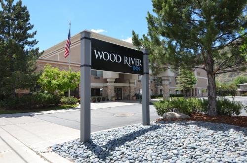 a sign for wood river inn in front of a building at Wood River Inn & Suite in Hailey