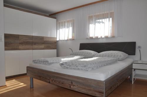 a bedroom with a bed with two pillows on it at Haus Assinger in Hermagor