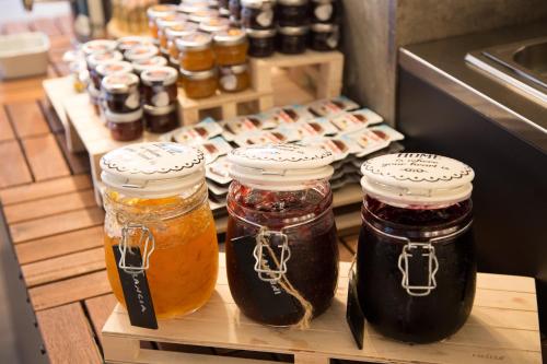 a group of jars of honey on a shelf in a refrigerator at Best Western Plus CHC Florence in Florence