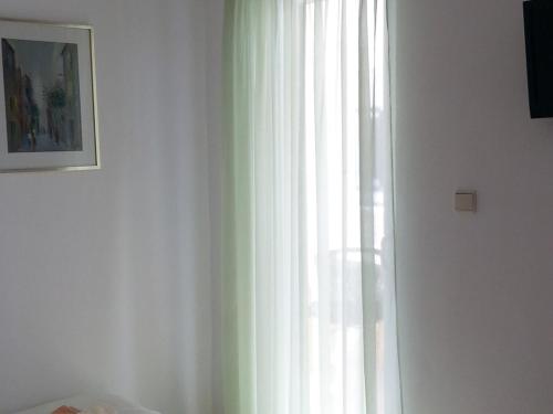 a window with white curtains in a room at Studio in Pag/Insel Pag 15956 in Stari Okić