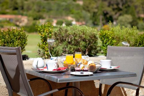a table with breakfast food and drinks on it at Logis Hôtel Restaurant des Corbières in Lagrasse