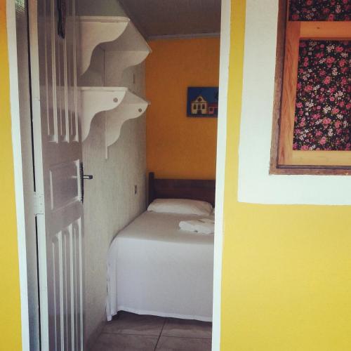a small bedroom with a bed in a room at SunriseBelaVista Pousada e Flats in Paraty