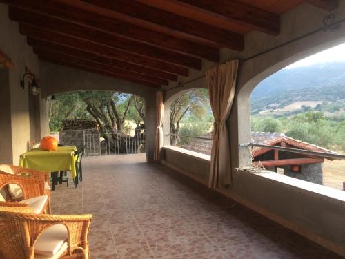a room with a balcony with a view at S'umbra de S'ozzastru in Orgosolo