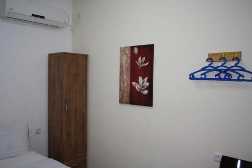 a bedroom with a bed and a picture on the wall at Ga'aton Motel in Nahariyya