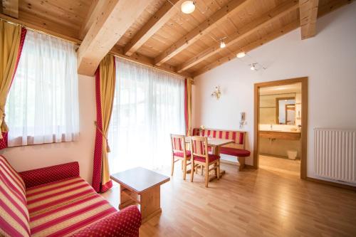 a living room with a couch and a table at Hotel Jager Hans in San Martino