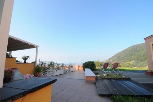 a patio with chairs and a view of a mountain at Hotel Residence Mondial in Moneglia