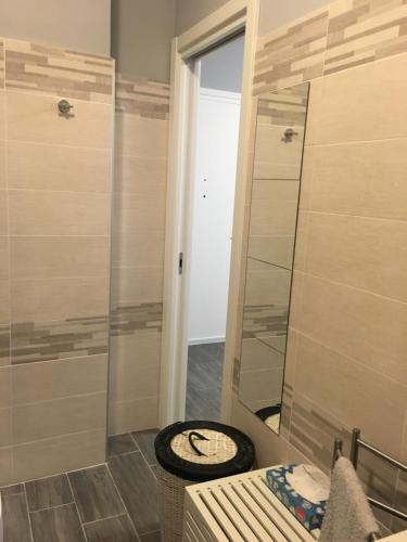 a bathroom with a shower and a toilet and a mirror at Casa di Ema in Sanremo
