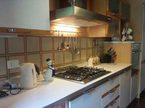 a kitchen with a stove and a counter top at Appartamento Angelo Emo in Venice-Lido