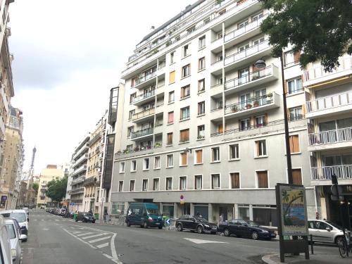 a large white building with cars parked in front of it at Red Flat Paris in Paris
