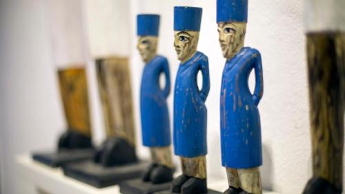 a group of wooden figurines of men with blue tops at Dar Indigo in Sidi Bou Saïd