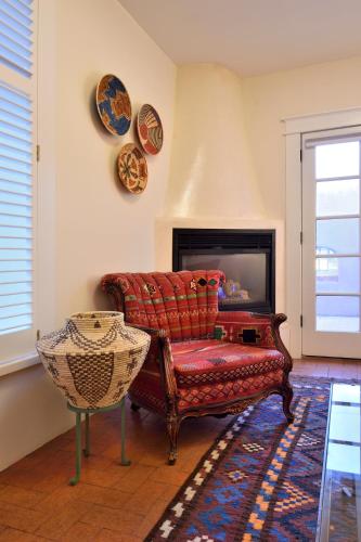 a living room with a couch and a fireplace at Casa Culinaria - The Gourmet Inn in Santa Fe