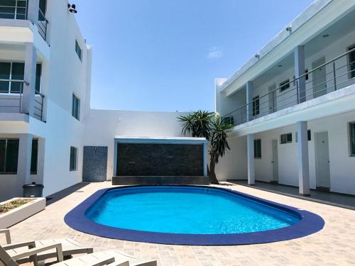 a swimming pool in the courtyard of a building at Mona Inn in Mazatlán