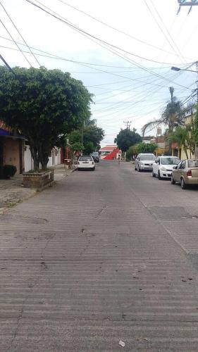 a street with cars parked on the side of the road at Posada San Cristobal in Cuernavaca