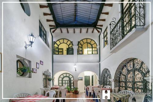a dining room with tables and chairs in a building at Hotel La Herreria Colonial in Popayan