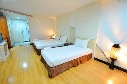 Ένα ή περισσότερα κρεβάτια σε δωμάτιο στο The Great Hotel Hatyai