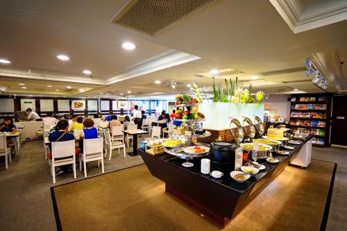 a buffet line with plates of food in a restaurant at Cambridge Tainan Hotel in Tainan
