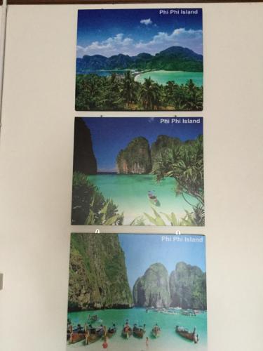 a collage of photos of the philippines on a wall at Pro Chill Krabi Guesthouse in Krabi