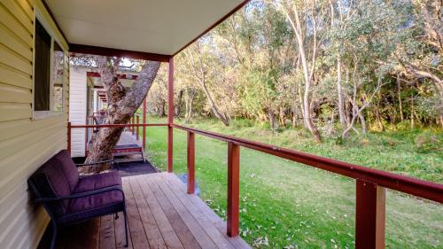 a porch of a house with a tree at Australind Tourist Park in Australind