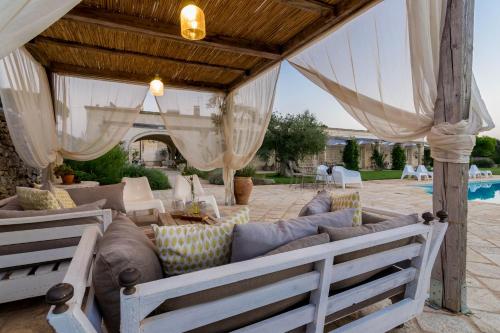 a living room with a couch under a pavilion at Masseria Sorani in Manduria
