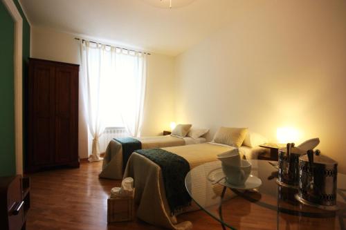 a bedroom with a bed and a large window at Palazzo Brigido in Trieste