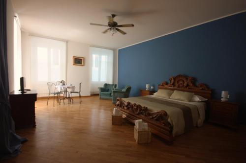 1 dormitorio con cama y pared azul en Palazzo Brigido, en Trieste