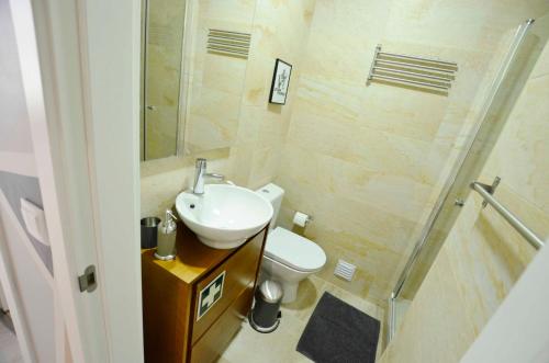 a bathroom with a sink and a toilet and a shower at The Red Jedi in Lisbon