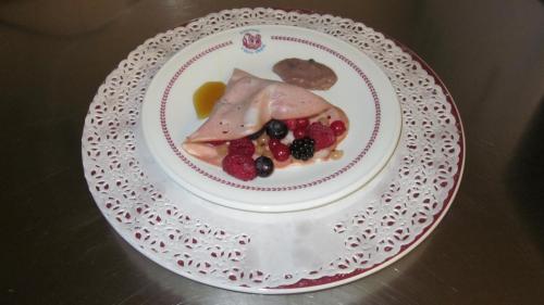 a plate of food with fruit on a table at Hotel Il Duca d'Este in Ferrara