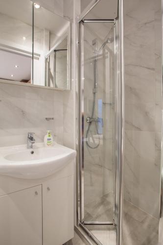 a bathroom with a shower and a sink at Apartments Calma in Cres