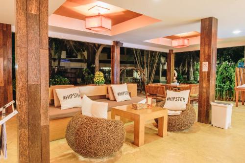 a living room with a couch and a table at The Hideaway Resort in Hua Hin