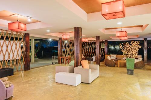 a lobby with couches and chairs at The Hideaway Resort in Hua Hin
