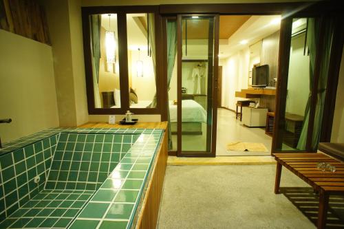 a bathroom with a green counter top in a room at The Hideaway Resort in Hua Hin
