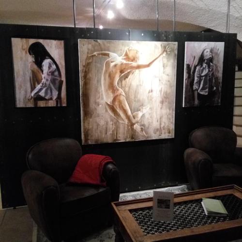a room with three paintings on a wall with chairs at Domaine de la Manse in Villeneuve-de-Berg