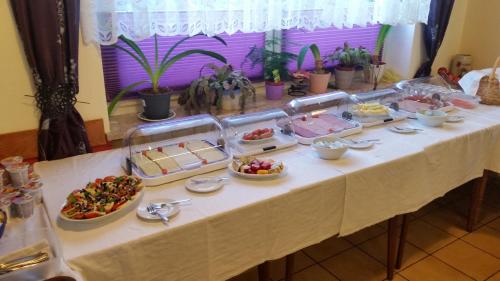 a table with a buffet of food on it at Hotel-Pension Dressel in Warmensteinach