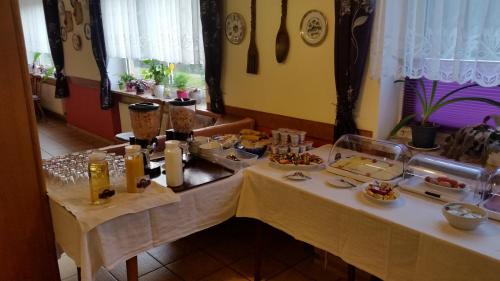 a table with a buffet of food on it at Hotel-Pension Dressel in Warmensteinach