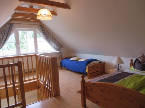 a bedroom with two beds and a staircase at Apartment Deller Renate in Leutschach