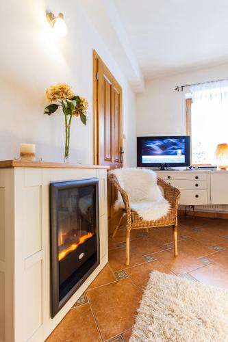 a living room with a fireplace and a desk at Villa Cynamon Jacuzzi & Sauna in Wisła