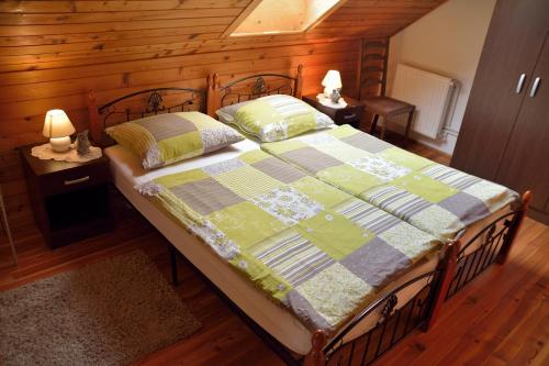 a bedroom with a bed with a quilt on it at Apartment Sotočje in Dolenja Trebuša