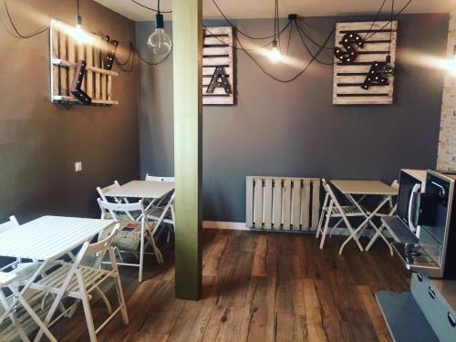 a dining room with white tables and chairs at Le Vintage in Ávila