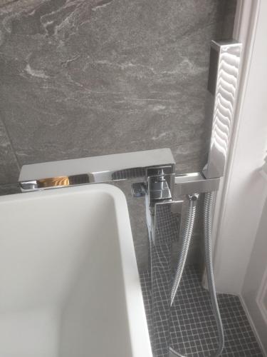 a bathroom with a sink and a toilet in a room at Sandpiper House in Whitby